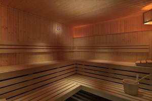 Innenansicht der Sauna im H10 Tenerife Playa Hotel mit Holzbänken und einem Holzeimer