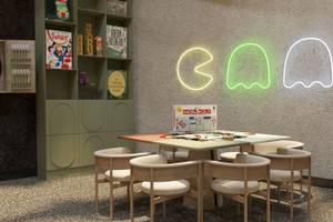 Spielzimmer im Ethno Belek Hotel mit grünen Möbeln und leuchtenden Pac-Man-Leuchten an der Wand.
