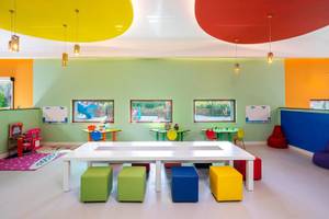 Bunte Kinderspielecke im Hotel mit farbenfrohen Möbeln und bunten Wänden.