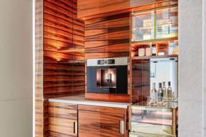 Zimmer im Fairmont Doha mit Holzschränken und Kaffeemaschine.
