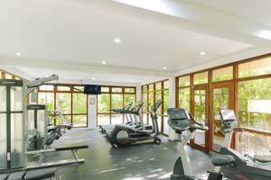 Fitnesscenter im Summer Island Maldives Hotel mit Geräten und Panoramafenstern.
