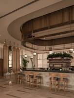 Barbereich im JAZ Riviera Hotel mit Holzstühlen und runden Deckenverkleidungen.