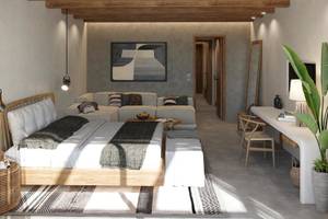 Modernes Hotelzimmer im JAZ Riviera mit Holzbalkendecke, einem großen Bett und Wohnbereich.