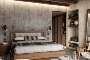 Hotelzimmer im JAZ Riviera mit grauen Wänden, einem großen Bett, Holzmöbeln und Dekor.