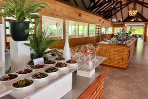 Buffettisch im Brennia Kottefaru Maldives mit verschiedenen Gerichten, Pflanzen und Cocktails.