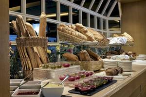Frühstücksbuffet im Pilot Beach Resort mit Brot, Aufschnitt, und Beilagen.