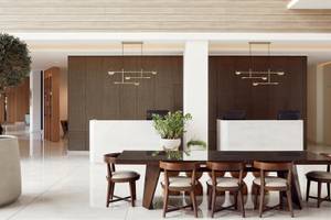 Lobby-Bereich des Mare Paphos Hotels mit Esstisch und Pflanzen.