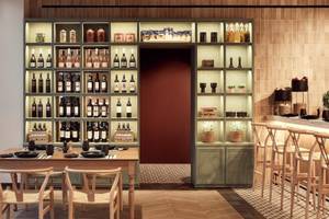 Innenbereich des Mare Paphos Hotels mit Esstisch, Stühlen und einer offenen Weinbar.