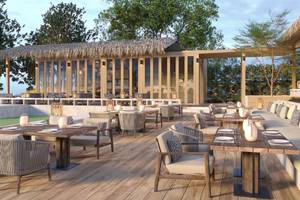 Außenterrasse des Anantara Koh Yao Yai Resorts mit Tischen und Stühlen unter einem Strohdach.
