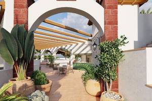 Begrünte Terrasse des Jardin Tecina Hotels mit Tischen und Stühlen unter einer Pergola